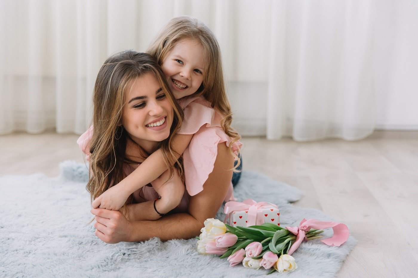 Happy mother’s day. Child daughter congratulates mom and gives h
